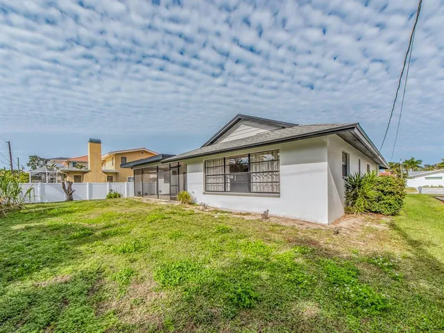 a house with huge green field in front of it