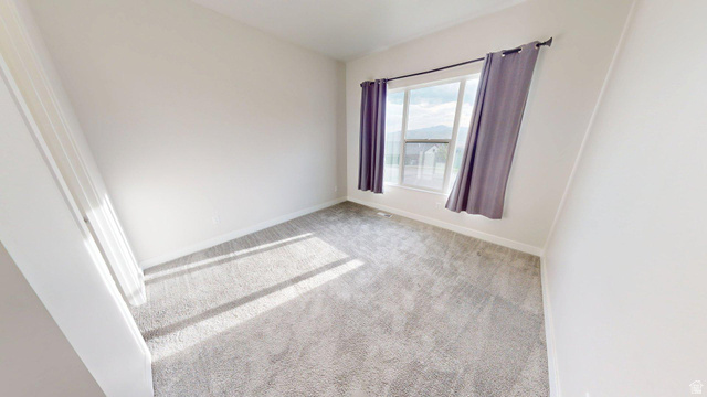 5502 North Valley View Road Lehi, UT 84048 - Photo 19 of 33 Carpeted room with a large window, neutral wall paint, and white trim