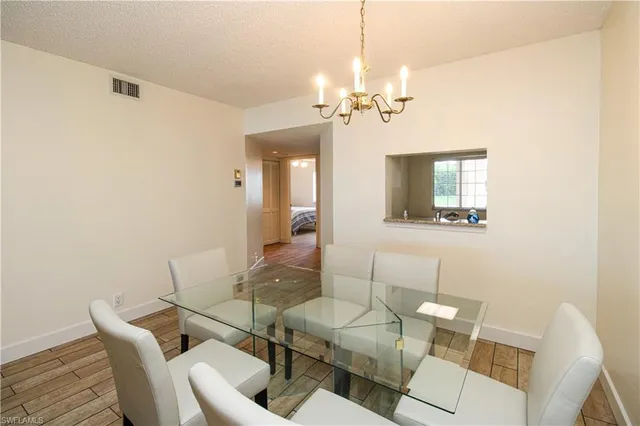 a view of a dining room with furniture and a chandelier fan