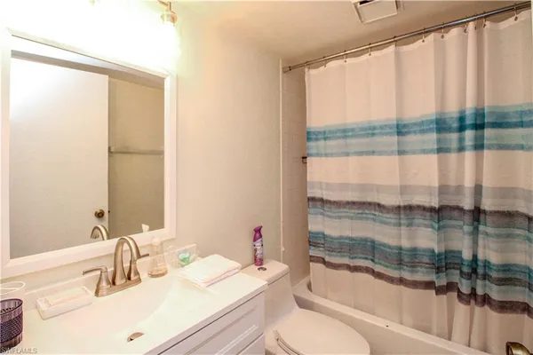 a bathroom with a sink a toilet and tub