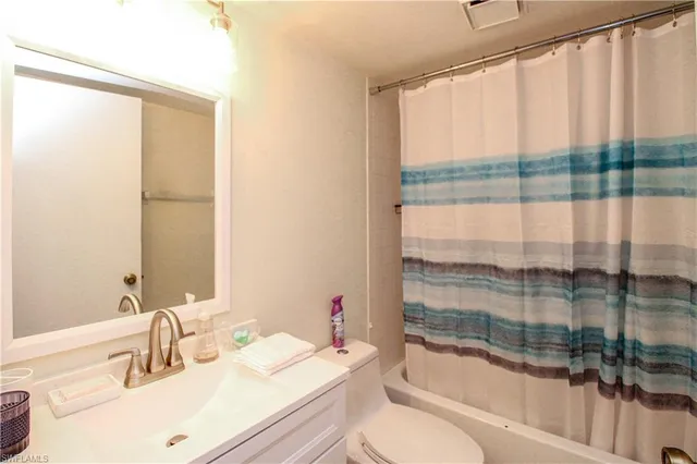 a bathroom with a sink a toilet and tub