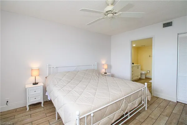 a bedroom with a bed and a lamp