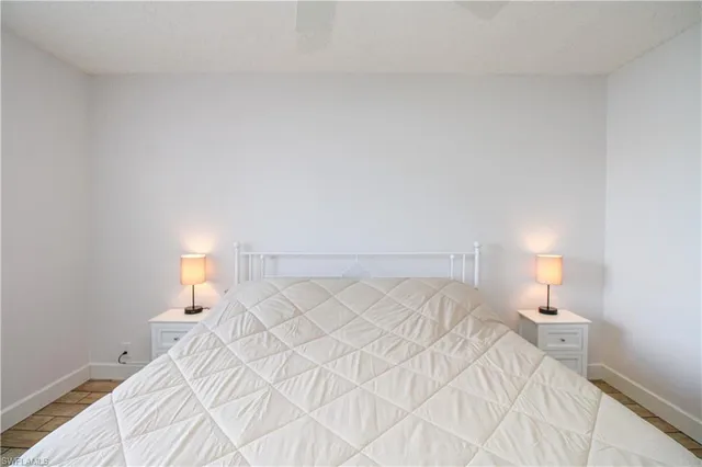 a bedroom with a bed and a night stand