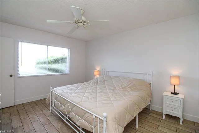 a bedroom with a bed and a night stand