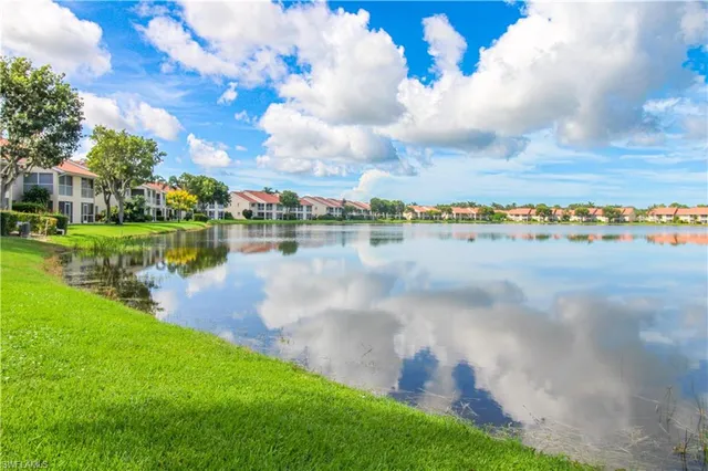 a view of a lake with houses in the back