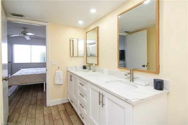 a spacious bathroom with a double vanity sink and mirror