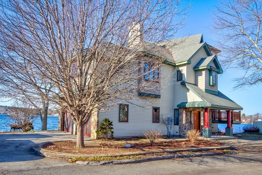 61 Colonial Road Webster, MA 01570 - Photo 3 of 42 a front view of a building with large trees