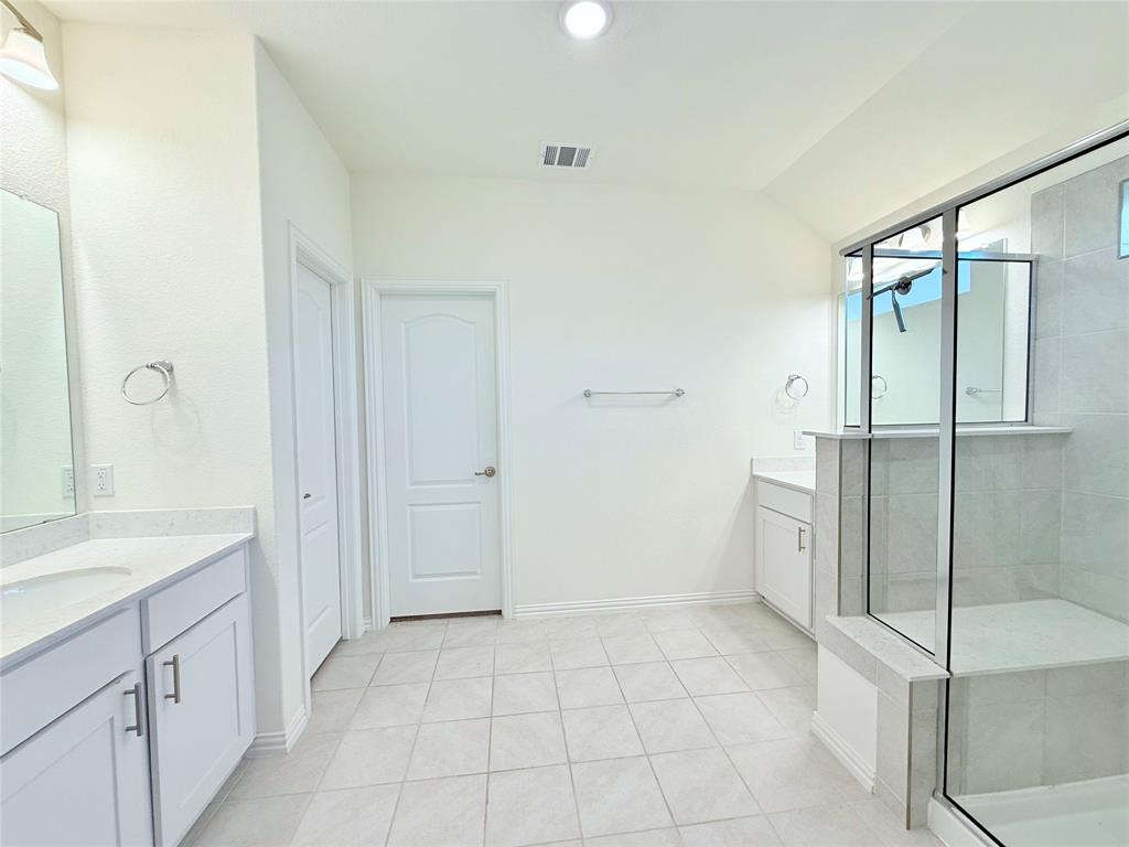 1336 Morning View Road Georgetown, TX 78628 - Photo 18 of 40 A spacious primary bathroom boasts a walk-in shower and dual vanities, perfect for unwinding.