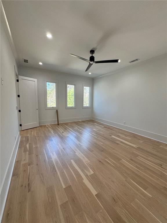 3425 Thompson Mill Road Buford, GA 30519 - Photo 41 of 48 an empty room with wooden floor and windows