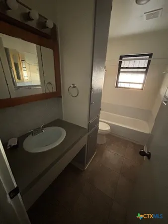 a bathroom with a toilet sink and bathtub