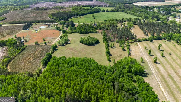 an aerial view of a house with a yard and lake view