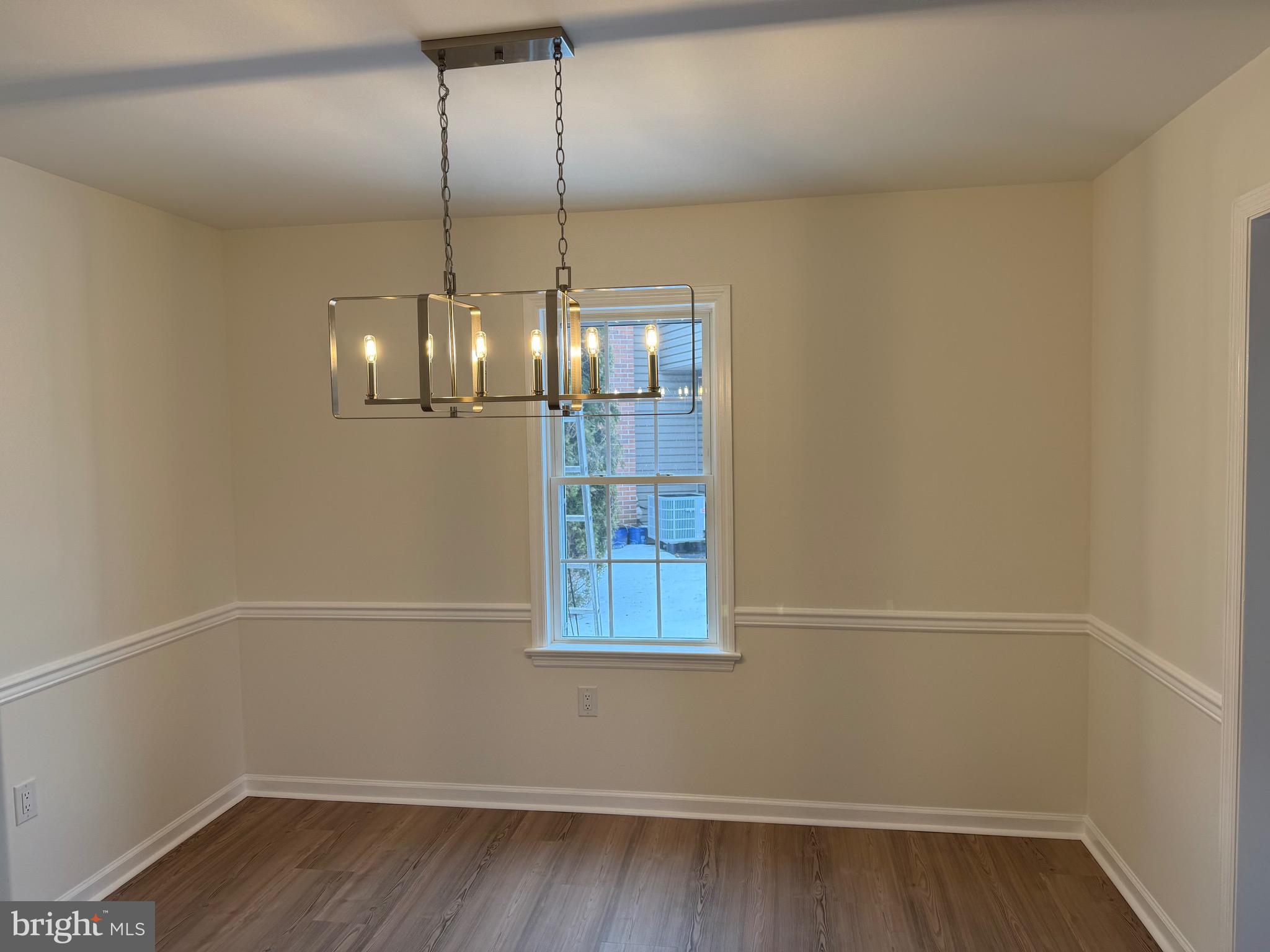806 Lightfoot Drive Lancaster, PA 17602 - Photo 18 of 21 a view of an empty room with wooden floor and chandelier