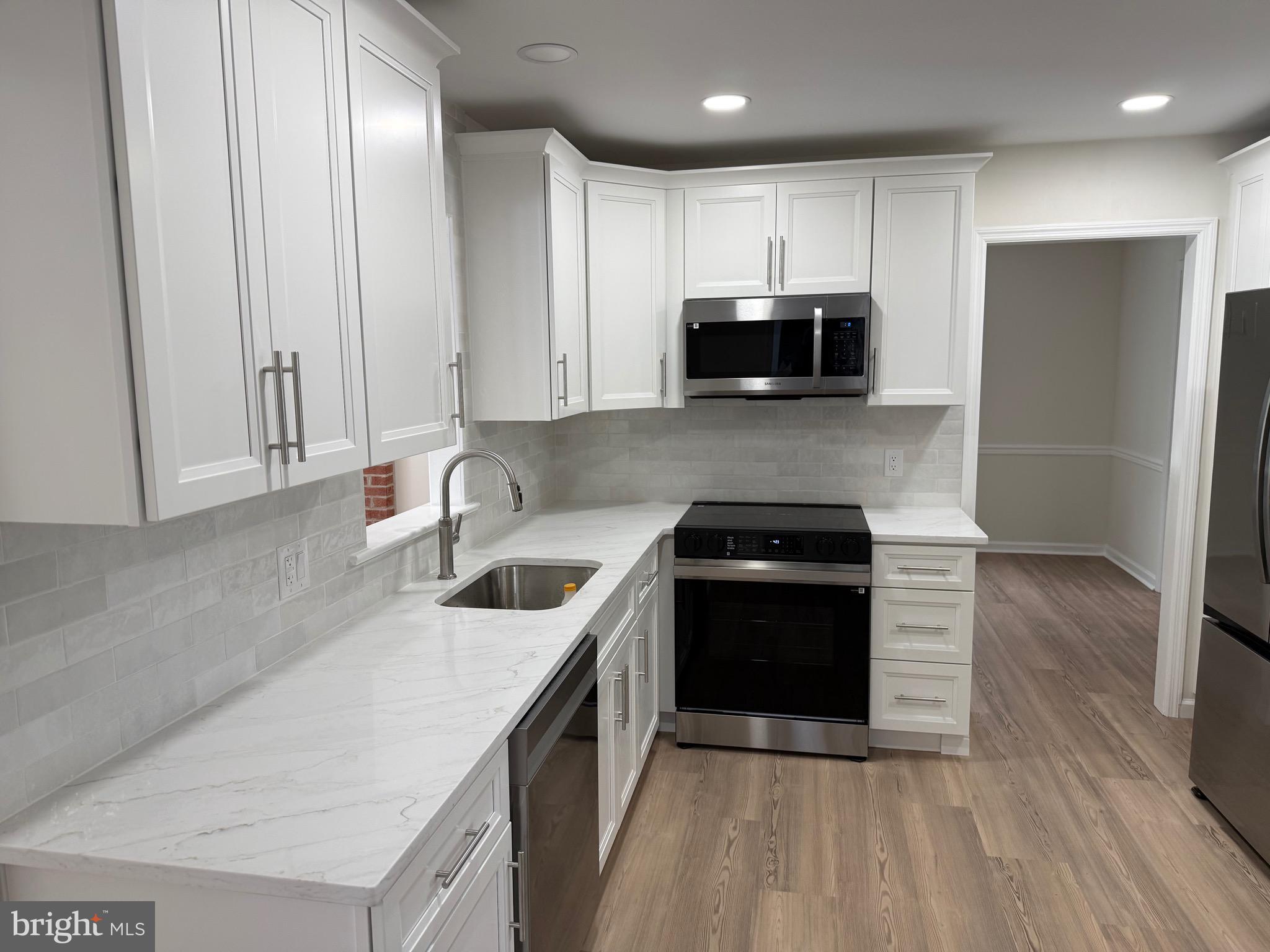 806 Lightfoot Drive Lancaster, PA 17602 - Photo 20 of 21 a kitchen with stainless steel appliances granite countertop a sink stove and refrigerator