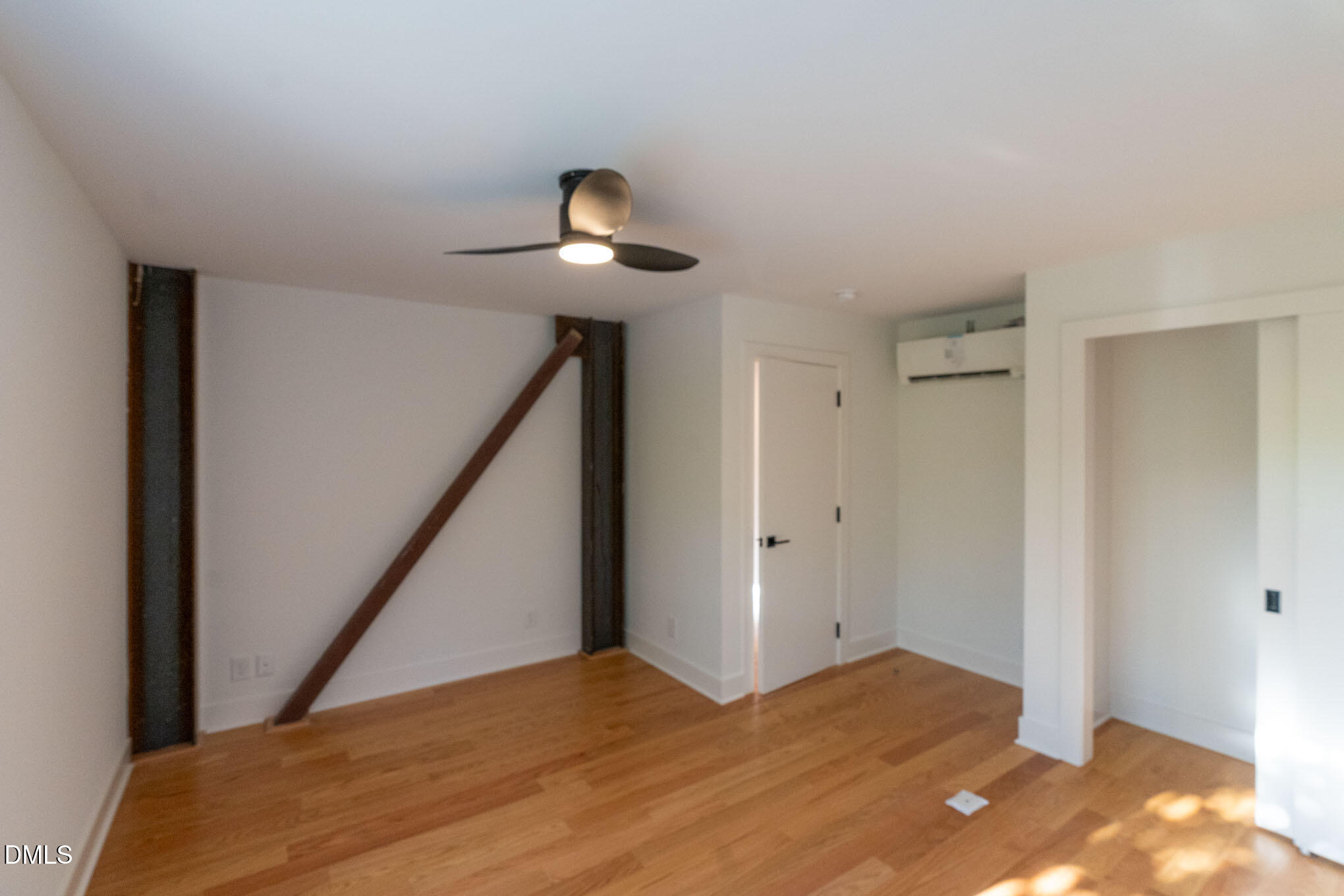402 East Martin Street Raleigh, NC 27601 - Photo 13 of 23 a view of an empty room with wooden floor and stairs
