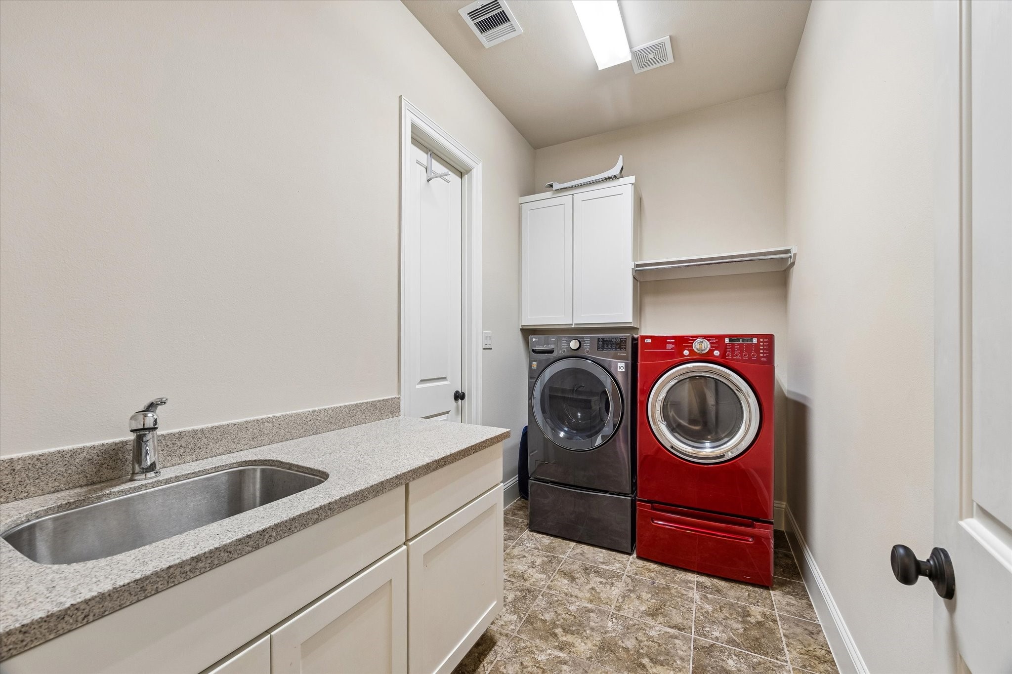 3 Tiburon Court Spring, TX 77389 - Photo 19 of 34 Just beyond, the laundry room is thoughtfully tucked away, making laundry day feel less like a chore and more like part of a well-designed routine. And then comes one of the home's smartest features: direct access from the laundry room into the expansive primary closet.