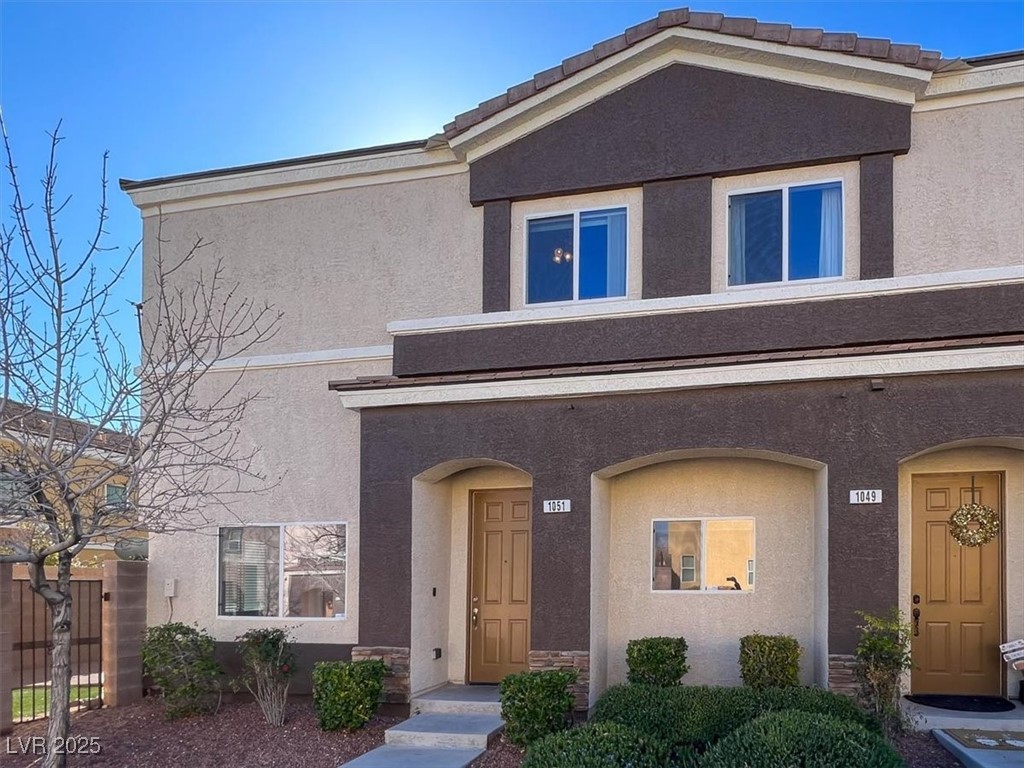 View of exterior entry with stucco siding