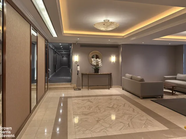 a living room with furniture and a large mirror