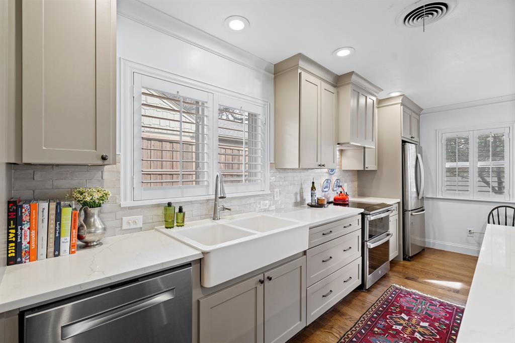 5322 Ridgelawn Drive Dallas, TX 75214 - Photo 11 of 30 a kitchen that has a lot of cabinets in it and wooden floor