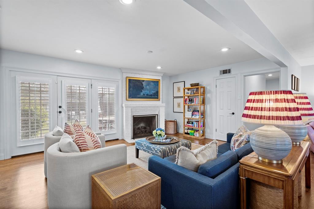 5322 Ridgelawn Drive Dallas, TX 75214 - Photo 14 of 30 a living room with furniture a fireplace and a flat screen tv