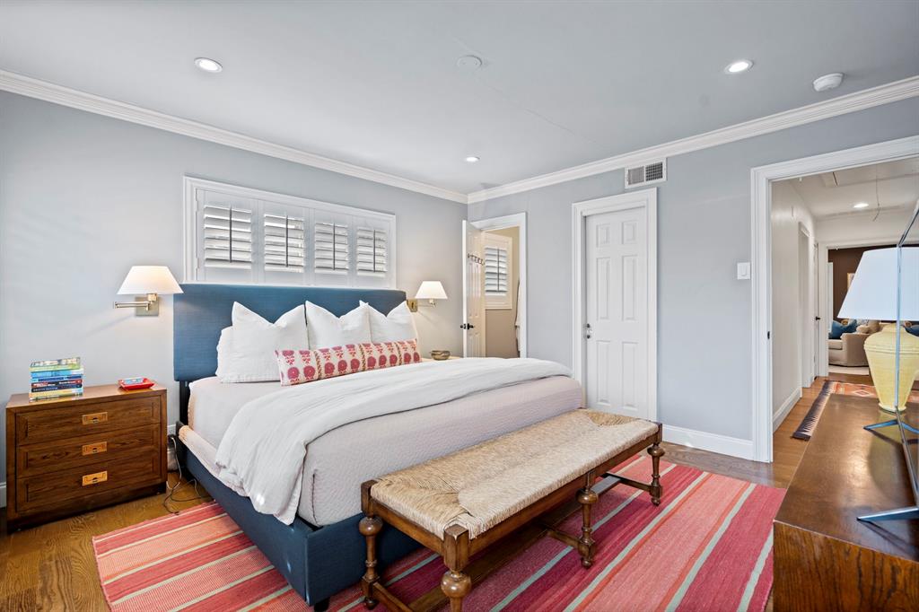 5322 Ridgelawn Drive Dallas, TX 75214 - Photo 18 of 30 a bedroom with a bed and wooden floor