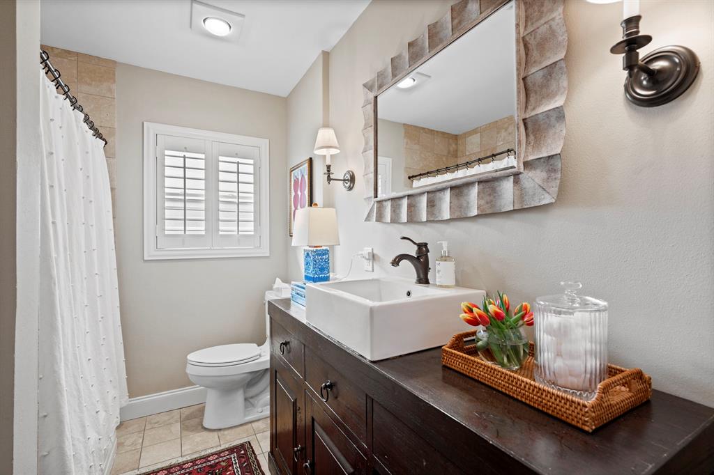 5322 Ridgelawn Drive Dallas, TX 75214 - Photo 20 of 30 a bathroom with a sink toilet and window