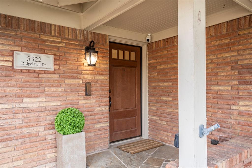 5322 Ridgelawn Drive Dallas, TX 75214 - Photo 2 of 30 a front view of a building with potted plants