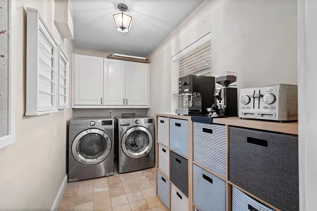 a utility room with sink dryer and washer