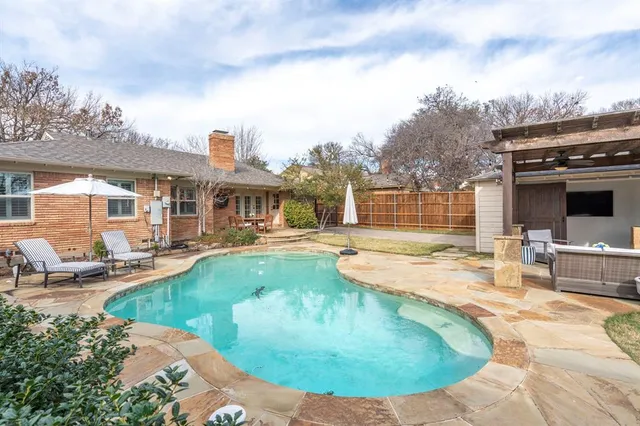 a view of a swimming pool with a patio