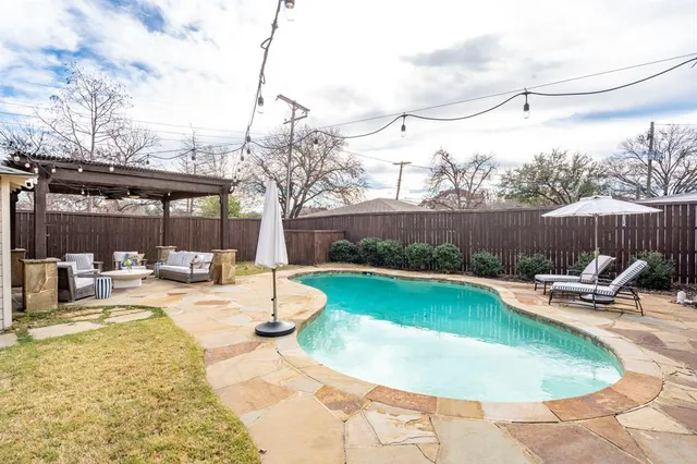 a view of a swimming pool with a patio