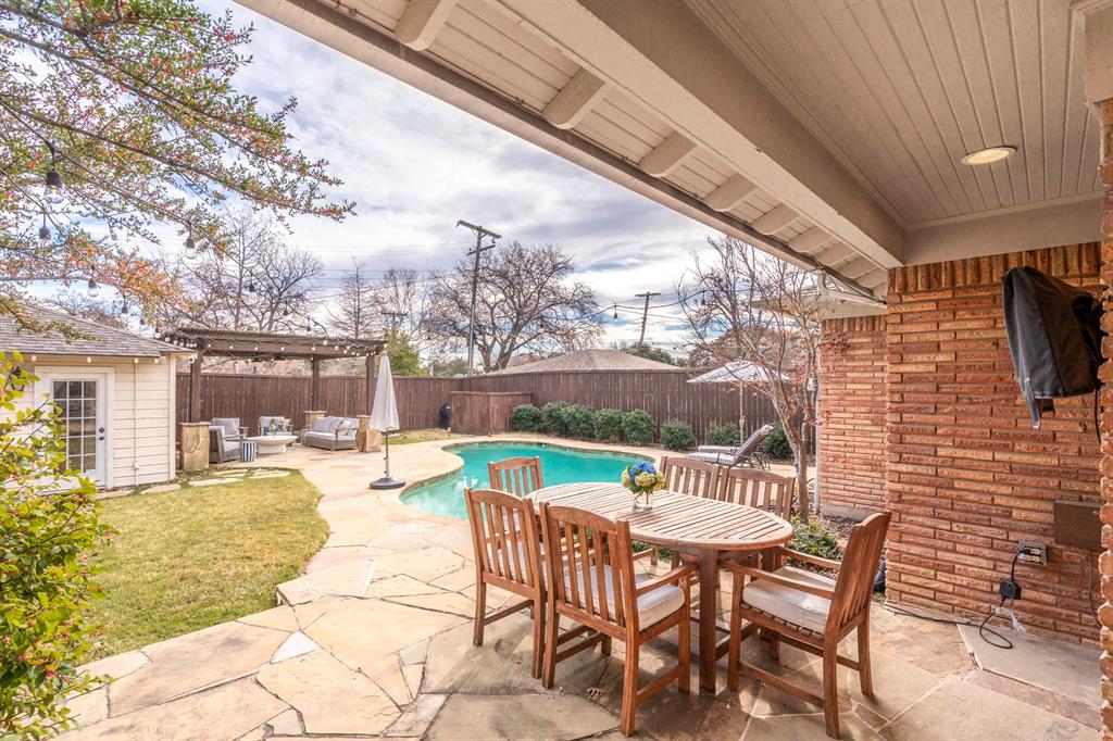 5322 Ridgelawn Drive Dallas, TX 75214 - Photo 30 of 30 a view of a patio with a table chairs and a wooden fence