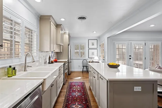a kitchen with a sink stove and cabinets