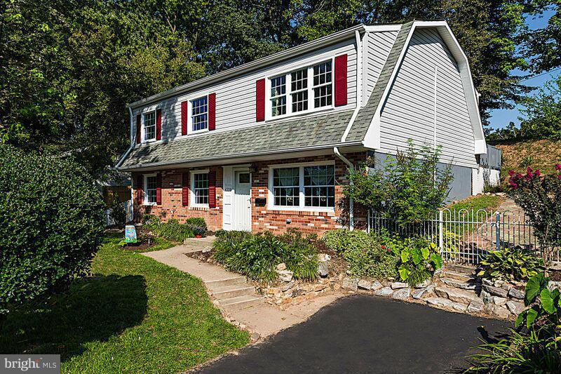 4220 Granby Road Woodbridge, VA 22193 - Photo 1 of 30 a front view of a house with a garden and trees