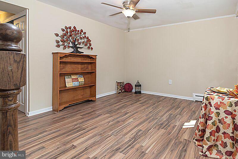 4220 Granby Road Woodbridge, VA 22193 - Photo 23 of 30 a view of a livingroom with wooden floor and a ceiling fan
