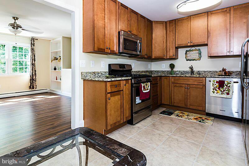 4220 Granby Road Woodbridge, VA 22193 - Photo 4 of 30 a kitchen with stainless steel appliances granite countertop a stove a sink and a microwave