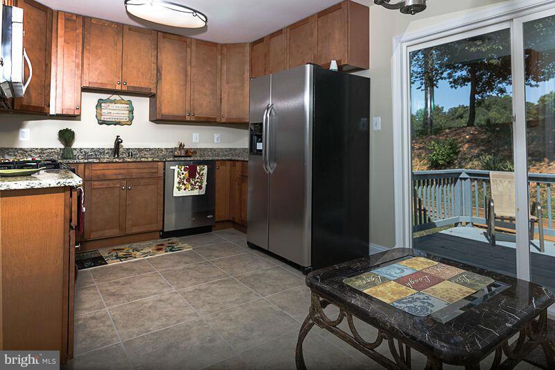 4220 Granby Road Woodbridge, VA 22193 - Photo 5 of 30 a kitchen with stainless steel appliances granite countertop a refrigerator and a stove top oven