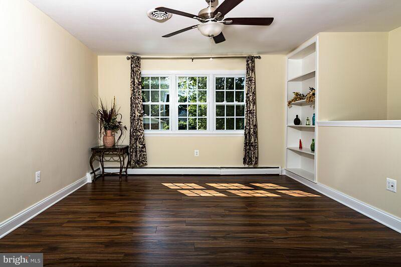 4220 Granby Road Woodbridge, VA 22193 - Photo 7 of 30 a view of a livingroom with wooden floor and a ceiling fan