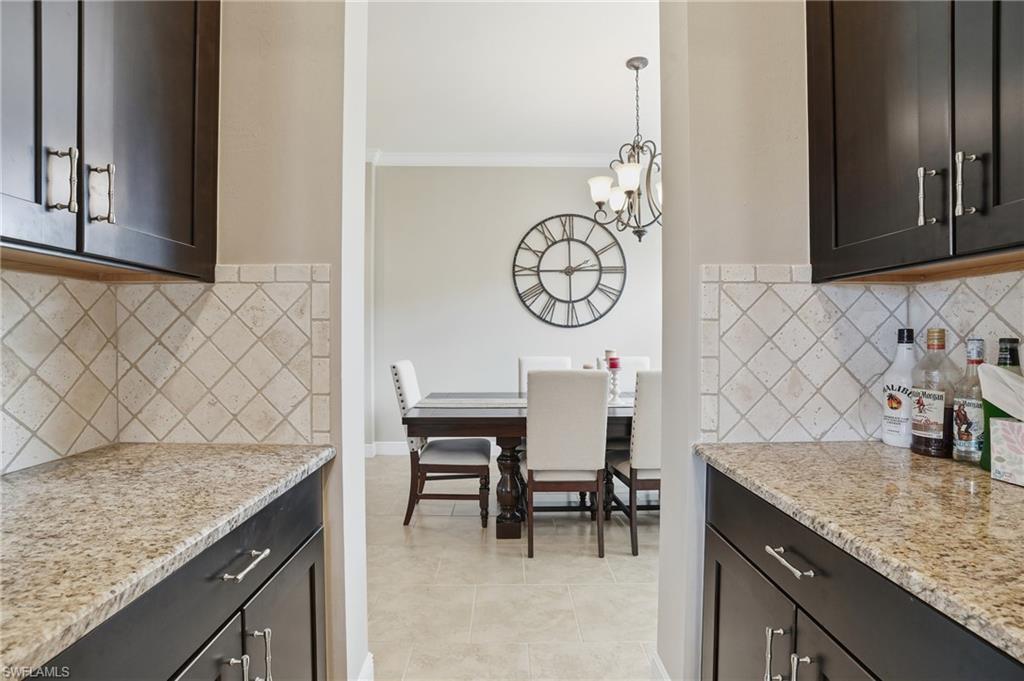 4609 Abaca Circle Naples, FL 34119 - Photo 12 of 49 a kitchen with a sink and cabinets