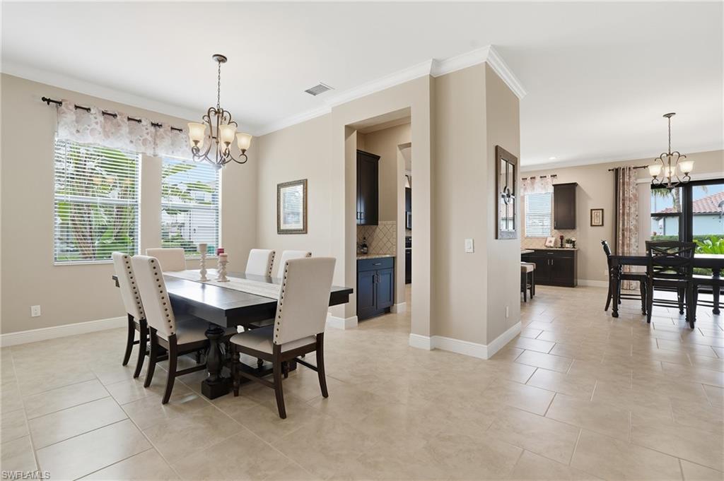4609 Abaca Circle Naples, FL 34119 - Photo 14 of 49 a view of a dining room with furniture window and wooden floor