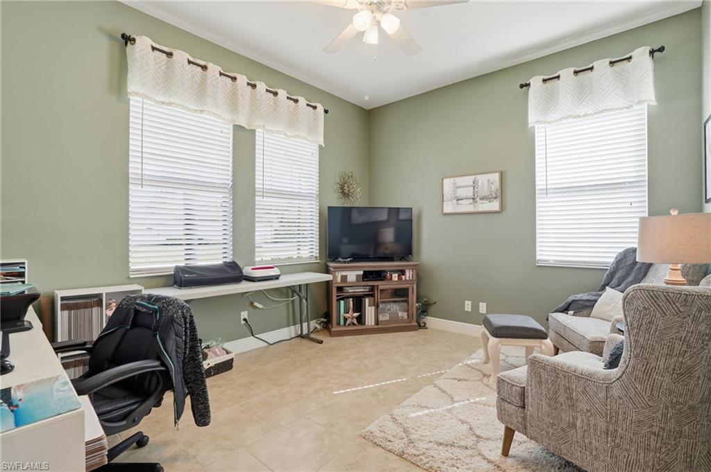 4609 Abaca Circle Naples, FL 34119 - Photo 15 of 49 a living room with furniture and a flat screen tv
