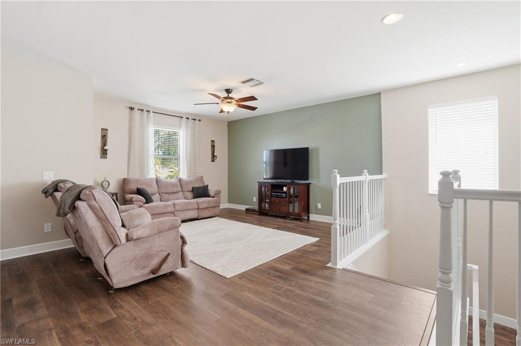 4609 Abaca Circle Naples, FL 34119 - Photo 17 of 49 a living room with furniture and a flat screen tv