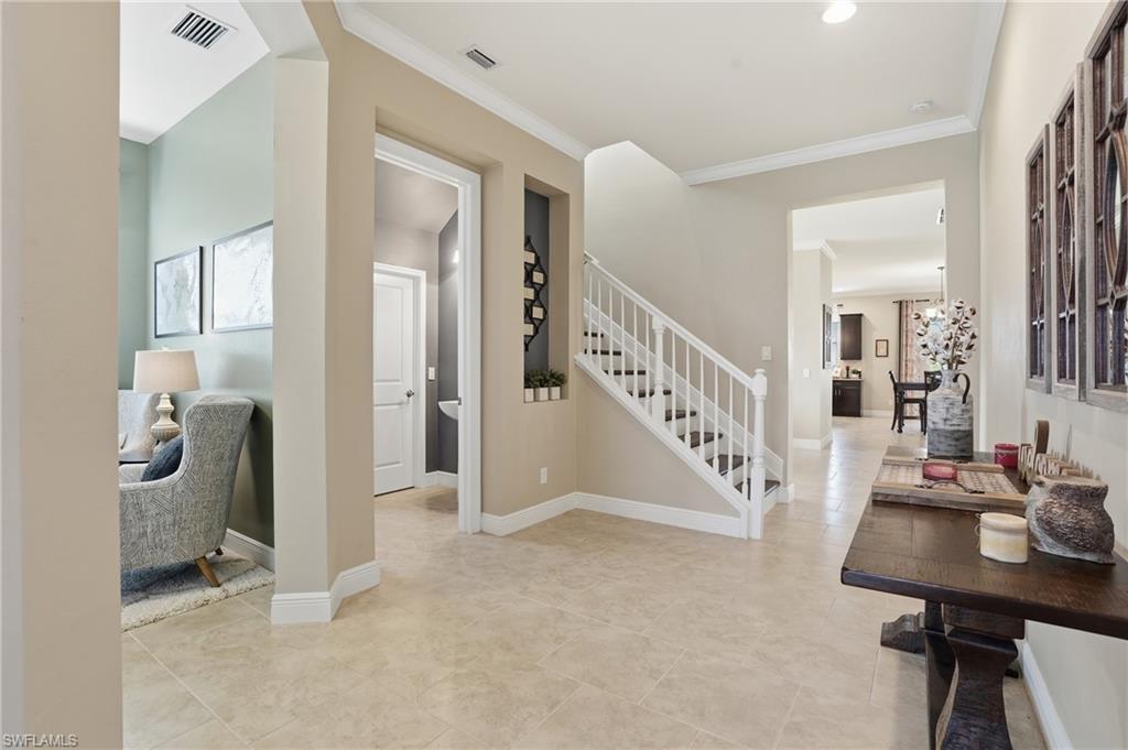 4609 Abaca Circle Naples, FL 34119 - Photo 2 of 49 a view of a livingroom with furniture and stairs