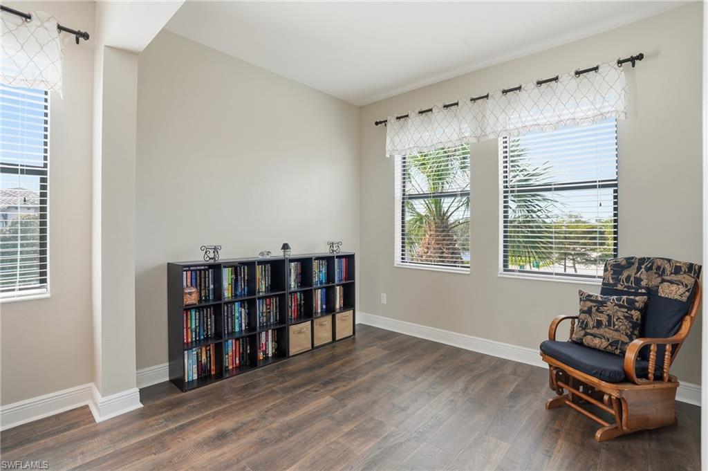 4609 Abaca Circle Naples, FL 34119 - Photo 23 of 49 a living room with furniture and a book shelf