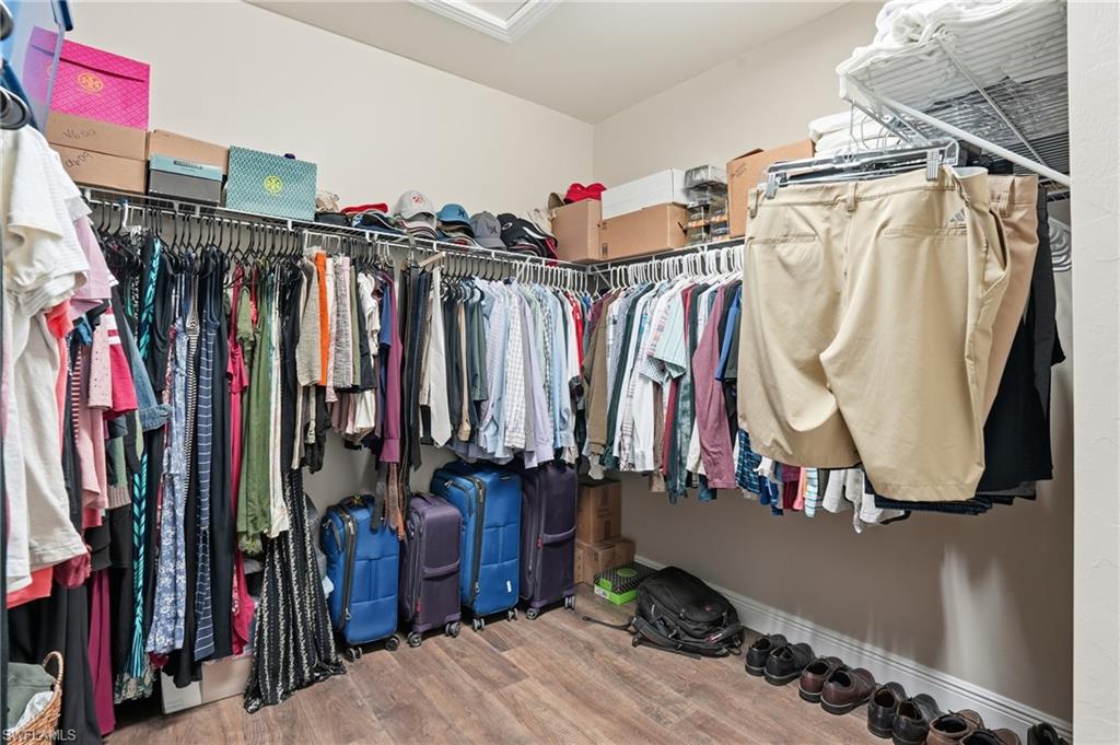 4609 Abaca Circle Naples, FL 34119 - Photo 27 of 49 a view of walk in closet with clothes and shoes