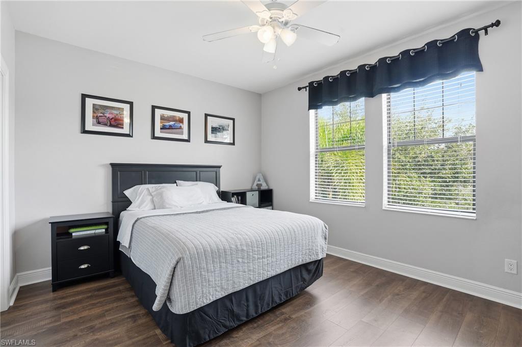 4609 Abaca Circle Naples, FL 34119 - Photo 32 of 49 a bedroom with a large bed and a chandelier