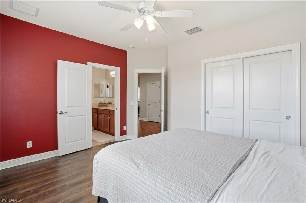 4609 Abaca Circle Naples, FL 34119 - Photo 33 of 49 a bedroom with a bed and a chandelier