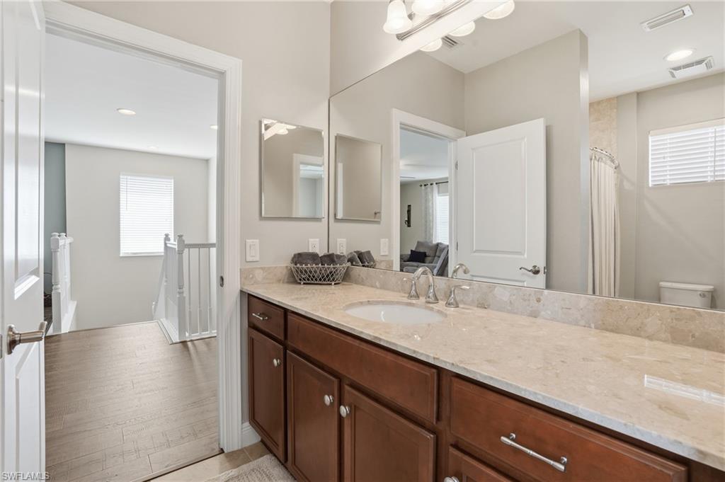 4609 Abaca Circle Naples, FL 34119 - Photo 34 of 49 a bathroom with a sink double vanity and a mirror