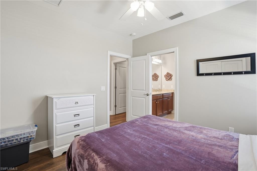 4609 Abaca Circle Naples, FL 34119 - Photo 35 of 49 a bedroom with a bed and a dresser