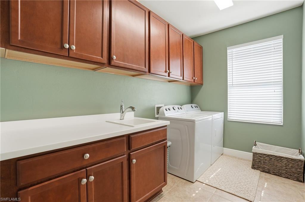 4609 Abaca Circle Naples, FL 34119 - Photo 36 of 49 a utility room with a sink washer and dryer