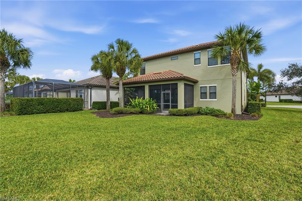 4609 Abaca Circle Naples, FL 34119 - Photo 39 of 49 a front view of a house with a yard