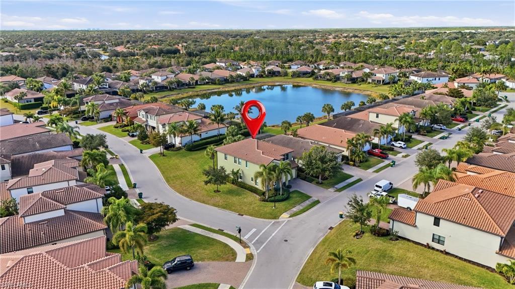 4609 Abaca Circle Naples, FL 34119 - Photo 40 of 49 an aerial view of lake and residential houses with outdoor space